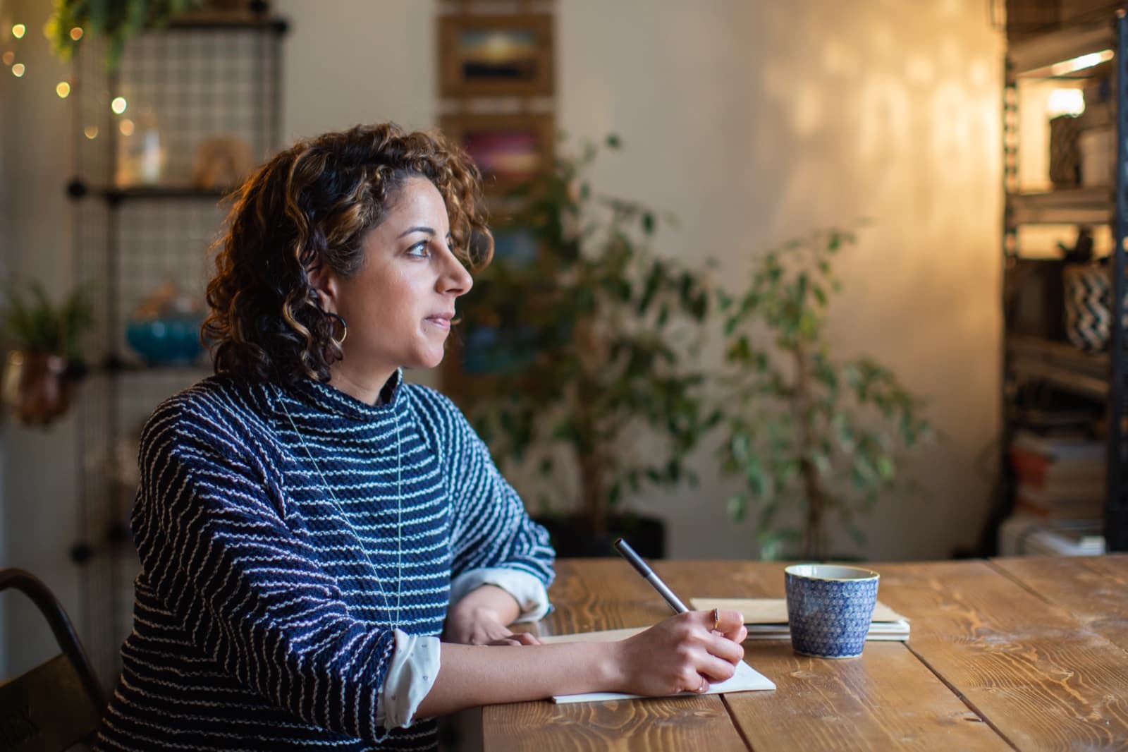 Natasha listening and taking notes in a one-to-one coaching session